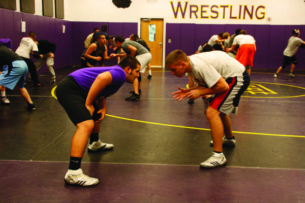 Junior Michael Galligan and Josiah McCoy line up to wrestle against each other during practice on Jan. 16.