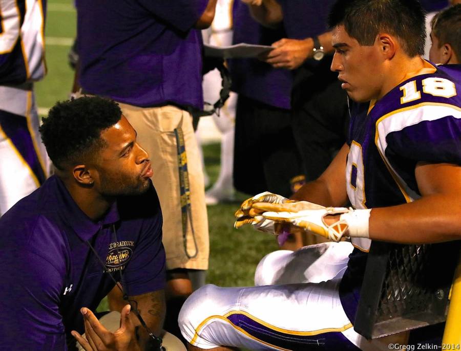 Coach Rickey Lewis discusses techniques with senior Steve Moreno.