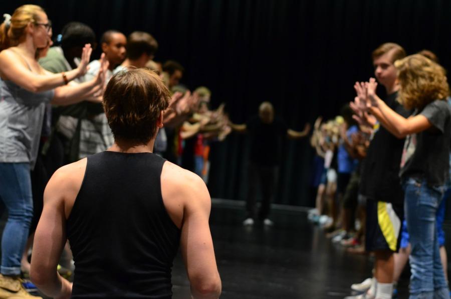 Theater students go through a warm-up activity during class.