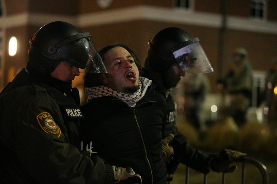 Police arrest people in the street outside the Ferguson Police Department in Ferguson, Missouri, on Nov. 25.