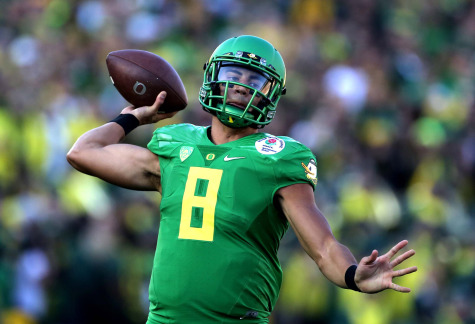 Marcus Mariota, Oregon's Hesiman-winning quarterback, looks to create a big play on offense.