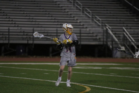 Freshman Mark Schubert gets ready to pass the ball in a game on March 24 against O’Connell.
