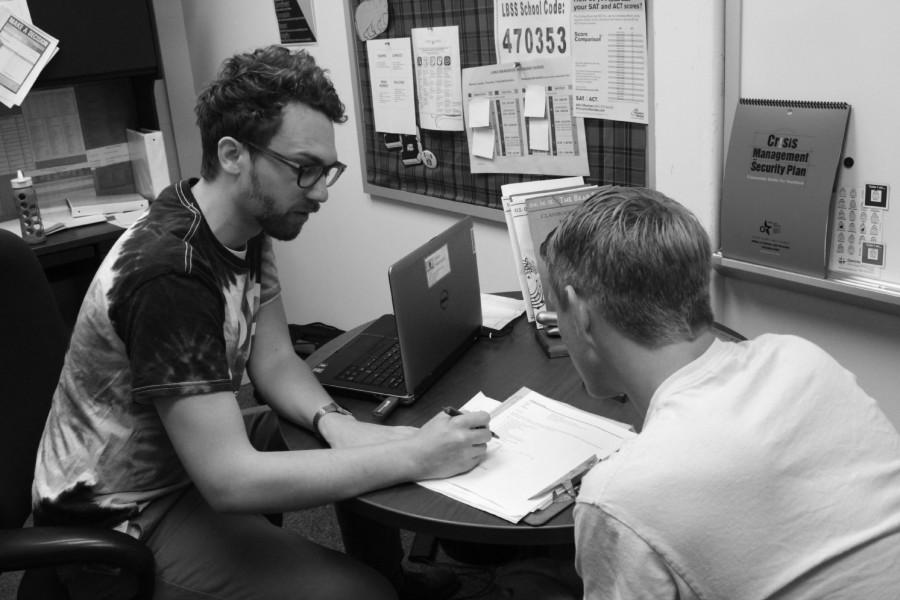 Counselor Dylan Hackbarth helps a student and he will be moving at the end of this year.