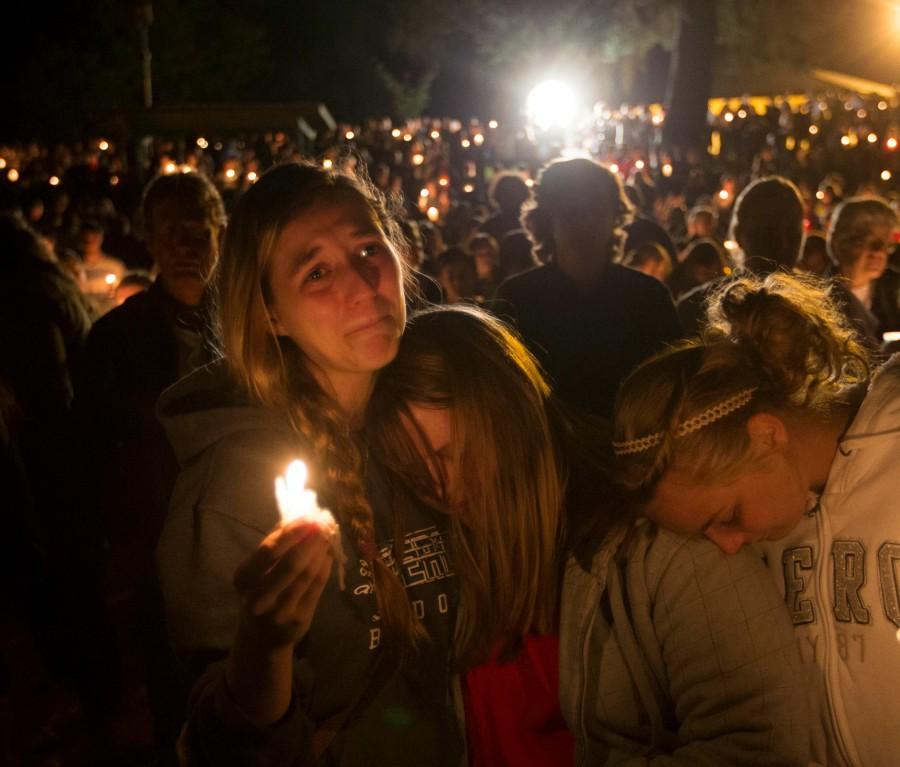 A group of young women console each other during a vigil on Oct. 1, 2015 in Roseburg, Ore. after a shooter opened fire at the Umpqua Community College, killing several. 