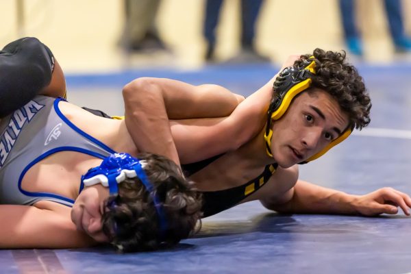 Junior Dylan Abeyta competes in a wrestling match